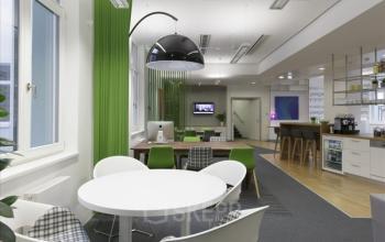 Modern and vibrant office space rental at Fleischmarkt 1, 1010 Vienna, featuring a well-lit workspace with ergonomic furniture and a relaxed atmosphere.